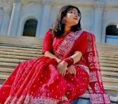 The traditional garment pictured is a Red Screen Print Half Silk Saree, a popular and affordable variation of traditional Bangladeshi cl