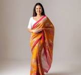 The garment shown in the image is an Orange Dual Tone Half Silk Jamdani Saree by the prominent lifestyle brand Aarong